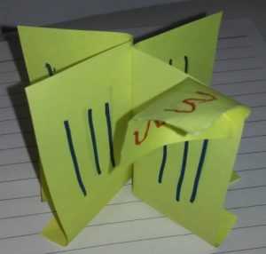 Sticky notes with verticla blue lines and one has a ticky note with red curly lines.