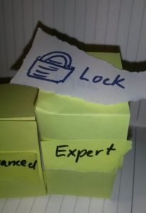 A piece of paper with a picture of a lock and "Lock" lies on a step with "Expert"